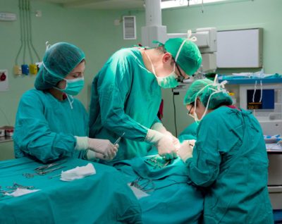 medical team performing surgery in scrubs